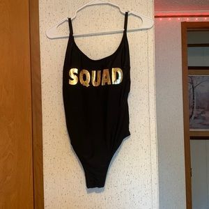 Black one piece swimsuit, golden word SQUAD on front, low back, size small